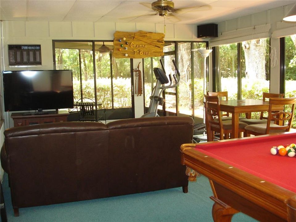 The Florida Room is sunny and bright, and overlooks both the backyard and the pool.