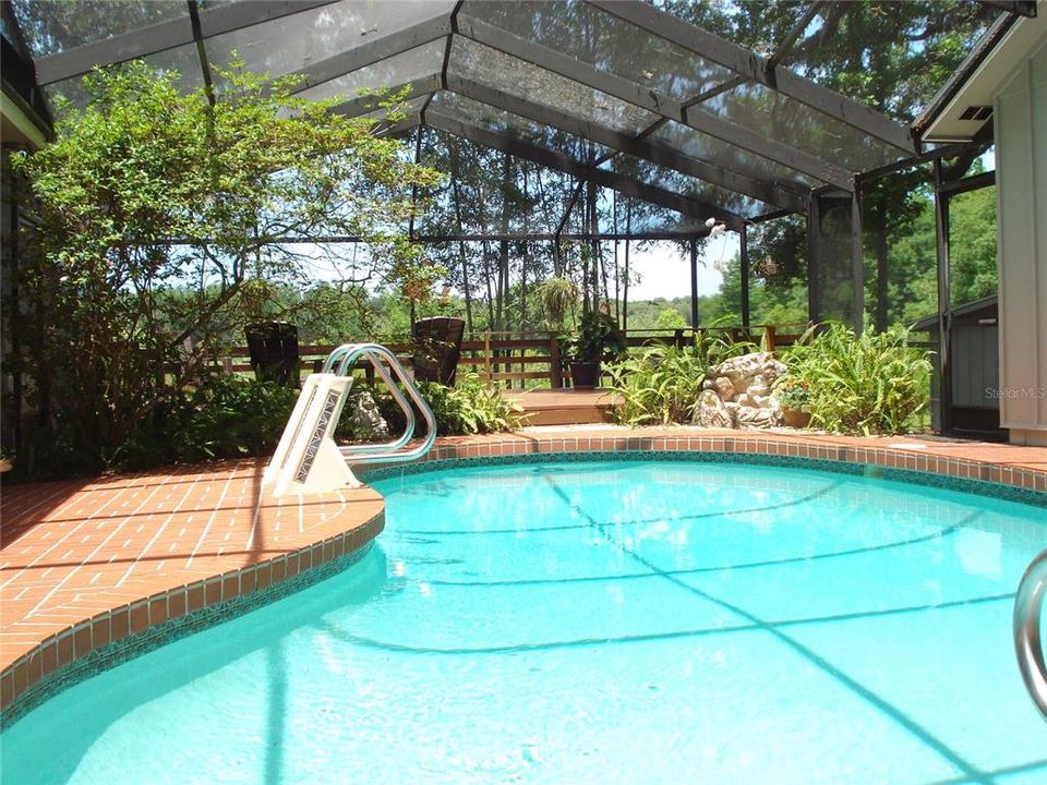 THIS SPARKLING GUNITE POOL INVITES YOU FOR A COOLING, RELAXING DIP.