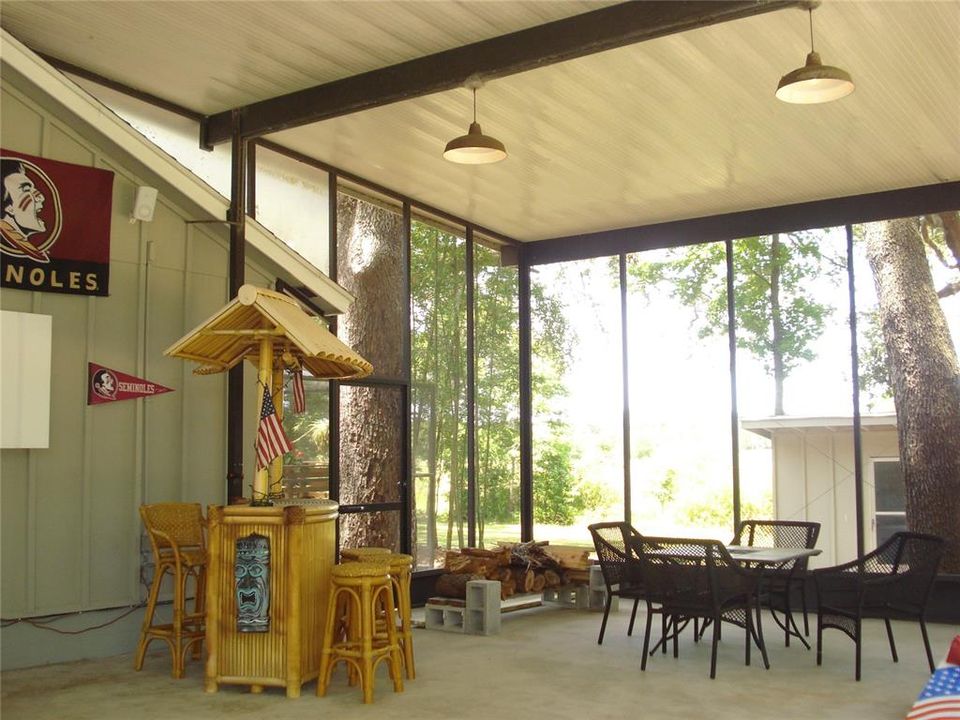 THIS HUGE RV OR BOAT HANGAR OR (you decide) IS ATTACHED TO THE GARAGE, AND IS CURRENTLY USED AS AN AMAZING FUN AND GAMES ROOM!  THE TIKI HUT AND PATIO SET IS INCLUDED!