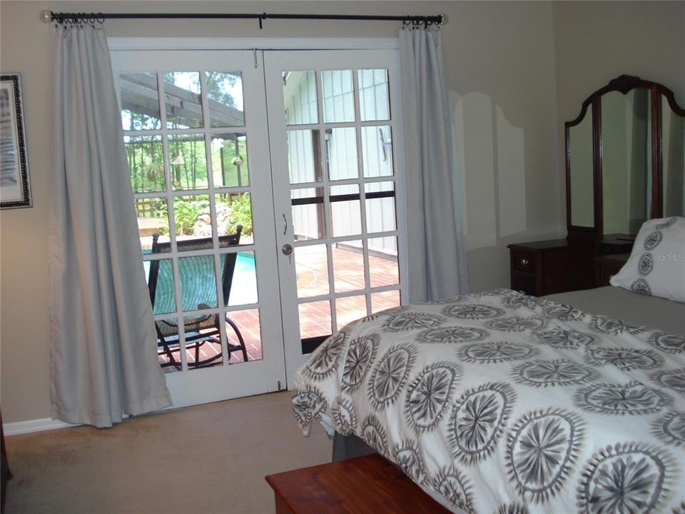 This bedroom has its own bath, and overlooks the pool.  Enter the pool deck through French Doors.