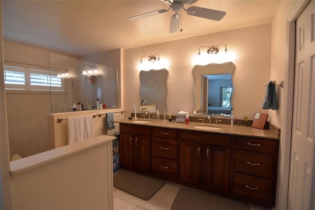 Primary bath with large walk-in shower and dual vanity.