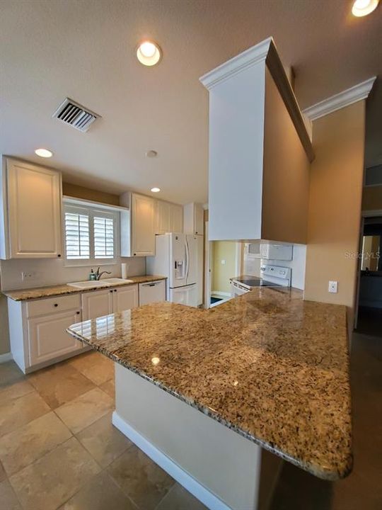 kitchen with granite counters and white cabinets