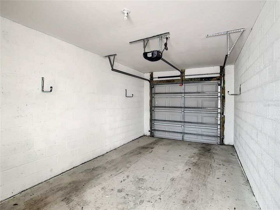 Single car garage with newer electric garage door.