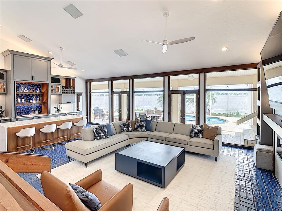 Living Room and Bar Area with View of Pool and Lake