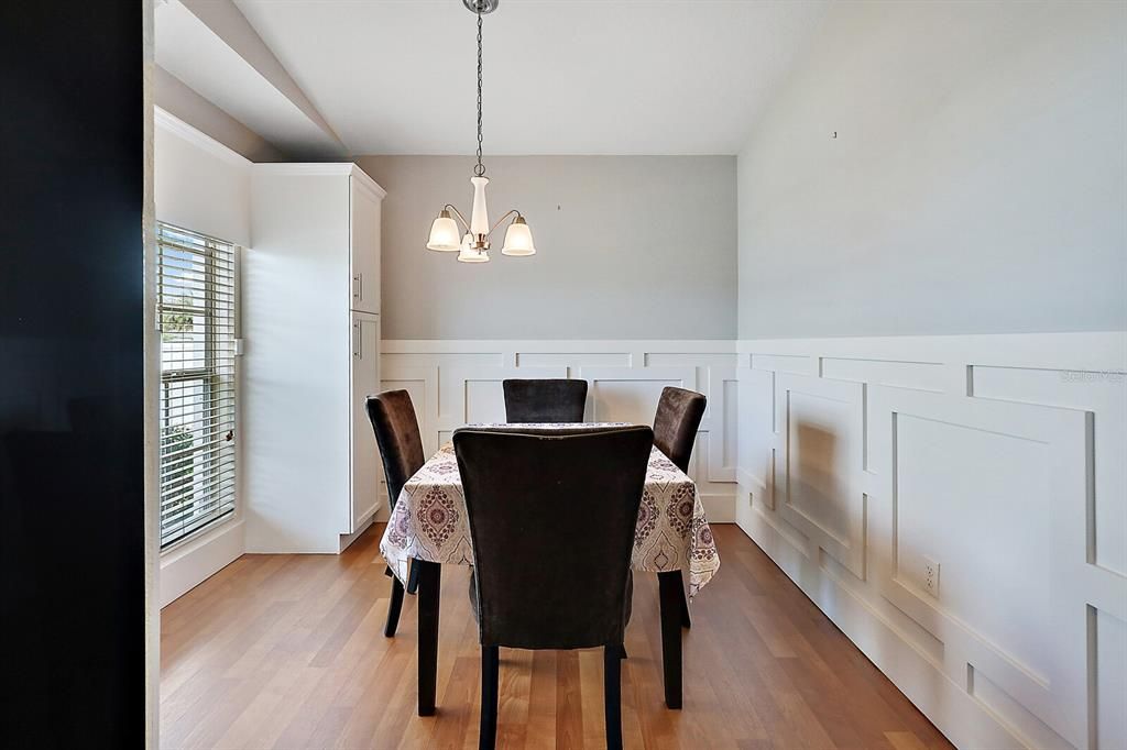 Dining Room with Laminate Flooring and Decorative Millwork