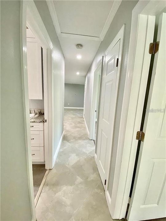 Hallway from 3 bedrooms that leads to the kitchen and great room