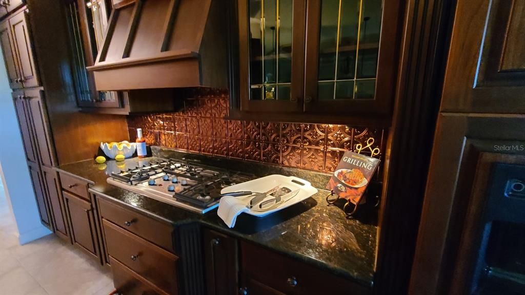 Gas Cooktop with Hearth Hood & Copper Backsplash