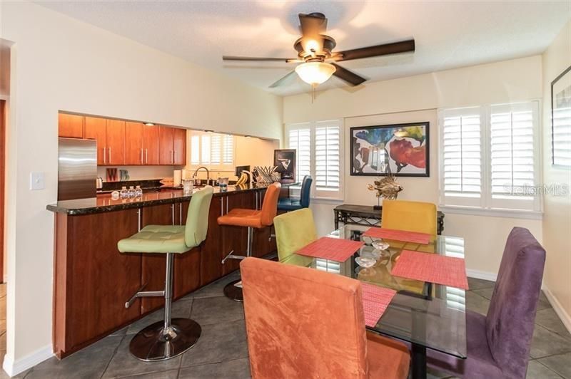 Upgraded Kitchen and and Dining Area with Shutters and Tiled Floors.