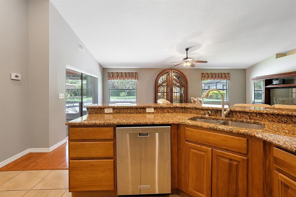 KITCHEN LOOKS OUT TO LIVING ROOM AND BACK PATIO