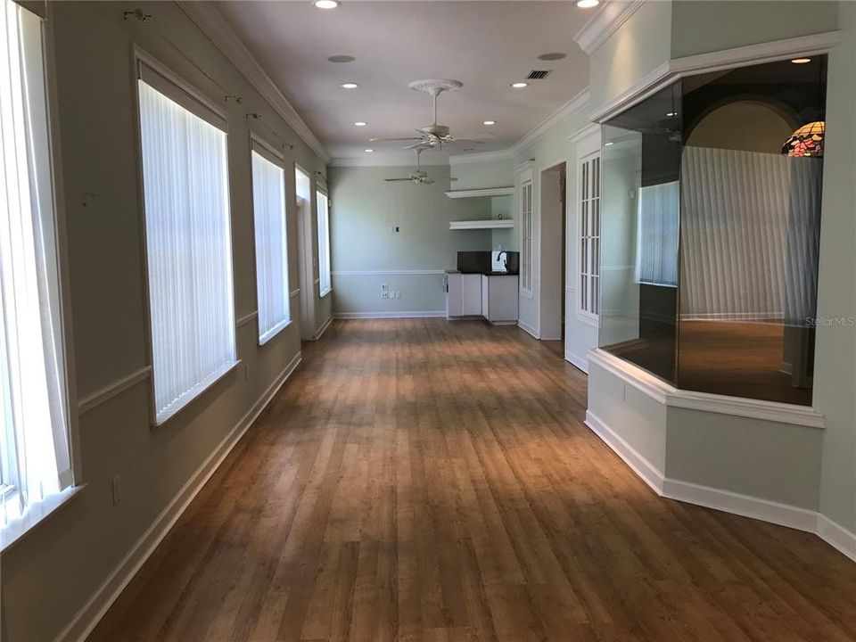 Air Conditioned Florida room with a Sink. Great for entertaining with a wall of Windows overlooking the Pond