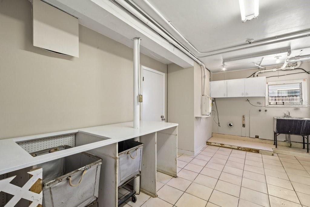 Laundry Suite with utility basin and 2 antique laundry bins. Gas is available in this area for your dryer.  There is a powder room as part of this suite, as well.