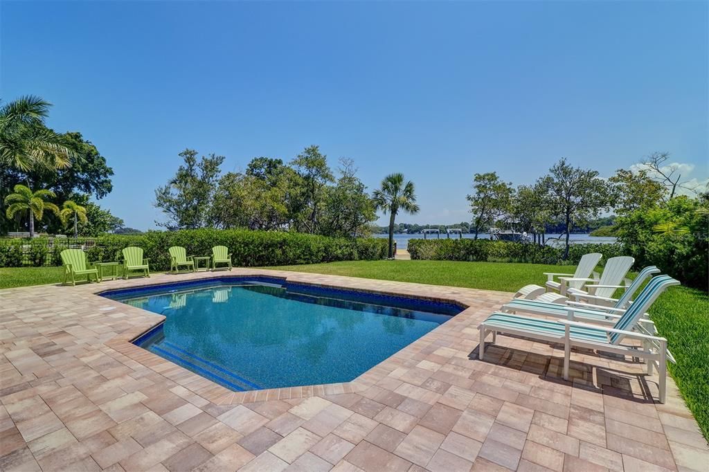 Beautiful pool and spacious back yard leading to the dock and riverfront.