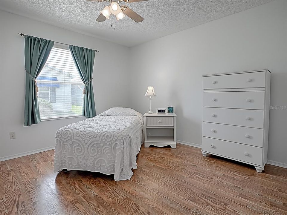 large guest bedroom, with laminate floors