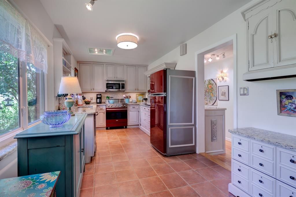 Kitchen. Viking Electric Range. 42 in Cabinets. Granite Counters. Terra Cotta Tile Floor. To the Right is the Lauundry area & 3rd Bathroom