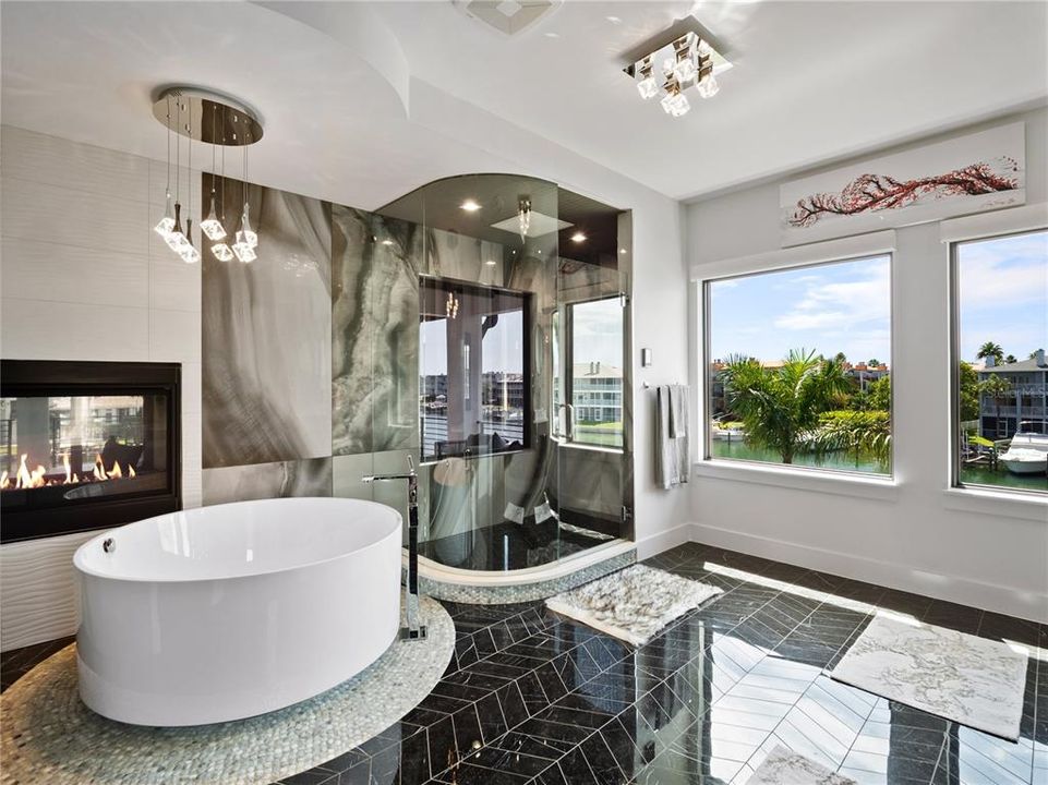 The master bathroom is a relaxing retreat with a 55-inch free-standing Japanese round soaking tub overlooking the fireplace.