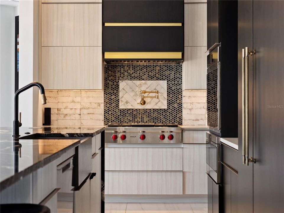 Top-of-the-line appliances will please even the most discerning home chef! From the Wolf gas stove with gridded and aged brass Brizo pot filler to the Bosch built-in coffee maker, Wolf drawer microwave and Sub-Zero separate column refrigerator with cabinet overlay.