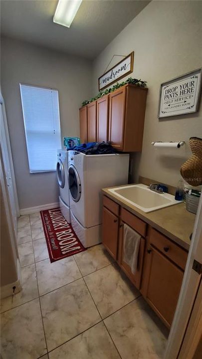 Large laundry room with storage and sink
