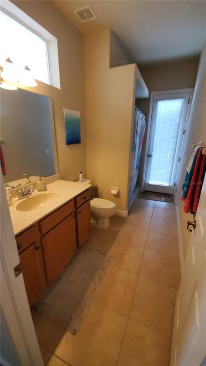 Full bathroom with pass thru to pool area