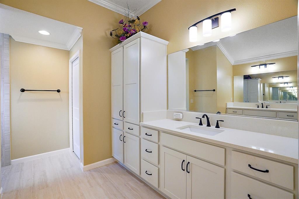 En suite with large vanity and extra cabinet space