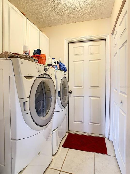 INSIDE LAUNDRY ROOM WITH PLENTY OF CABINET SPACE