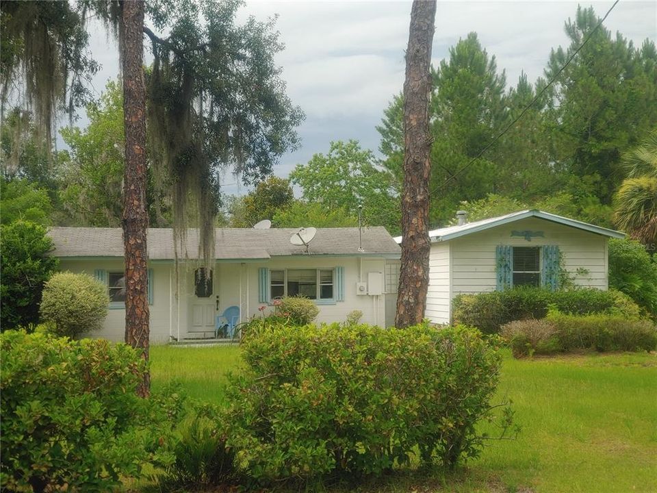 front view Block home on left & Manufactured home on right (connected by a breezeway/hall in between.