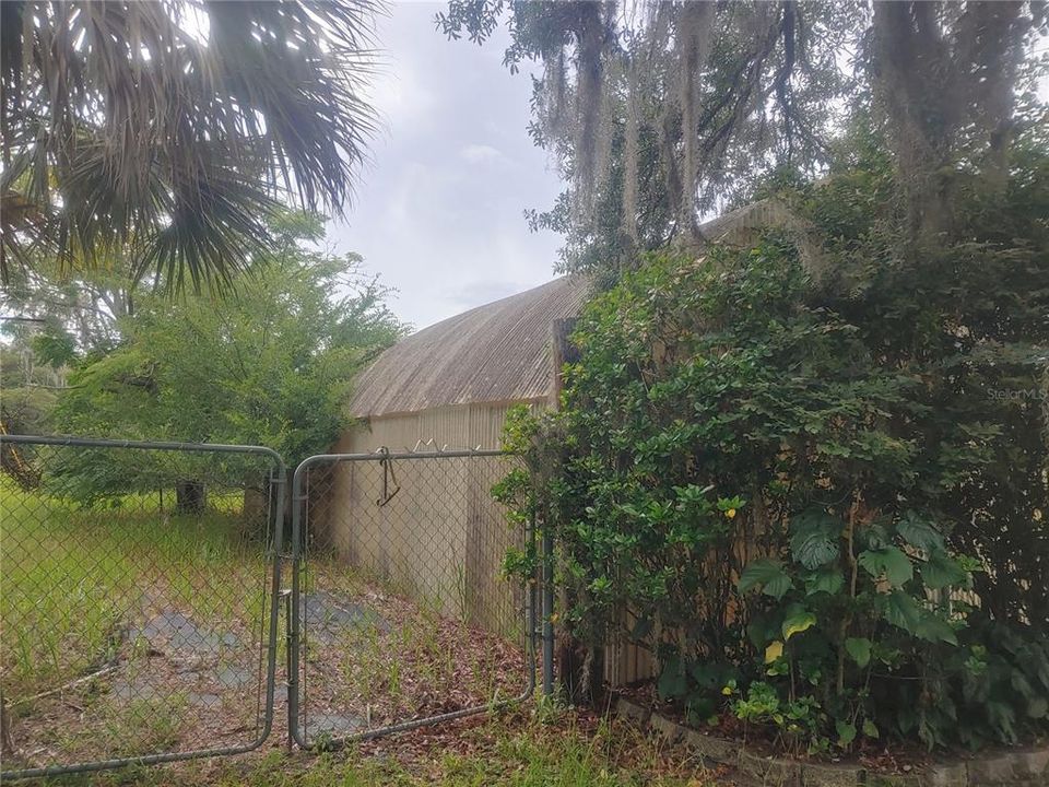 fenced area near greenhouse