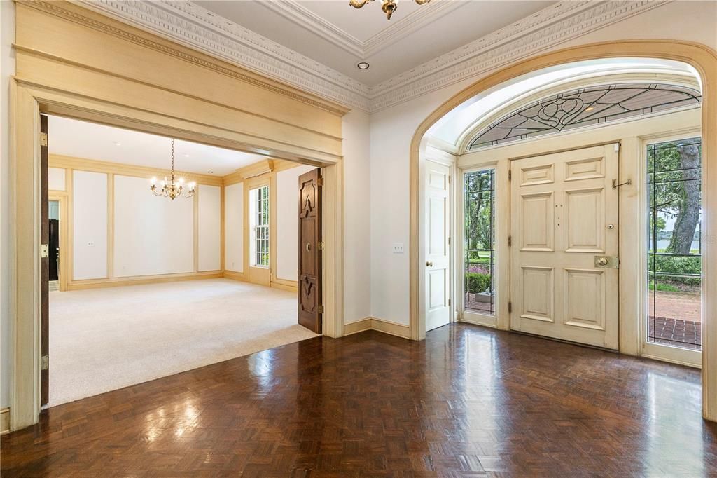 Oversized dining room directly off the foyer with custom hardwood bi-fold doors for a grand effect