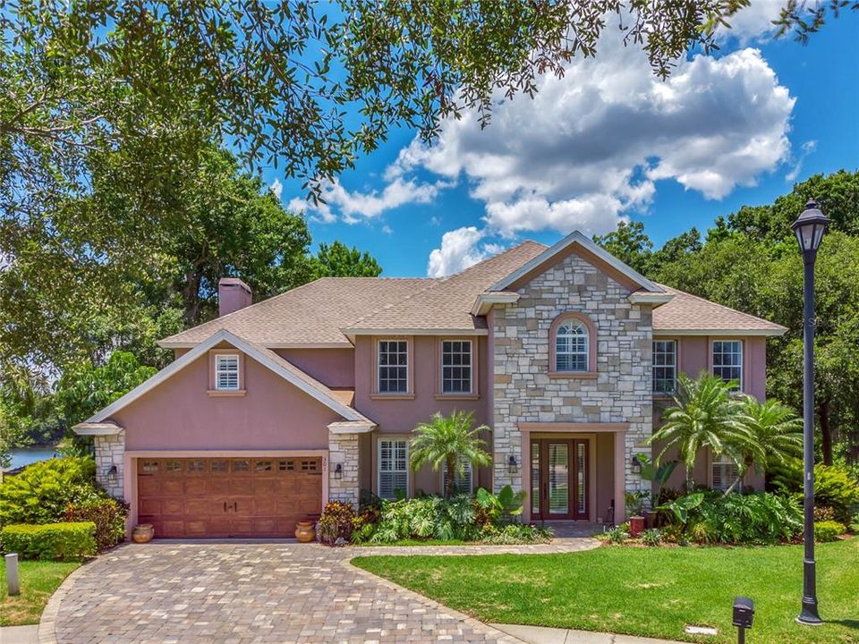 The front has beautiful stonework and a paver driveway and walkway