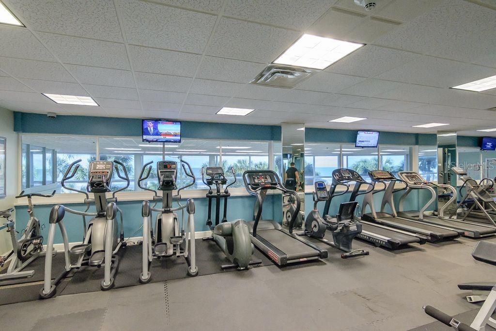 The fitness center is equipped with several types of cardio equipment.