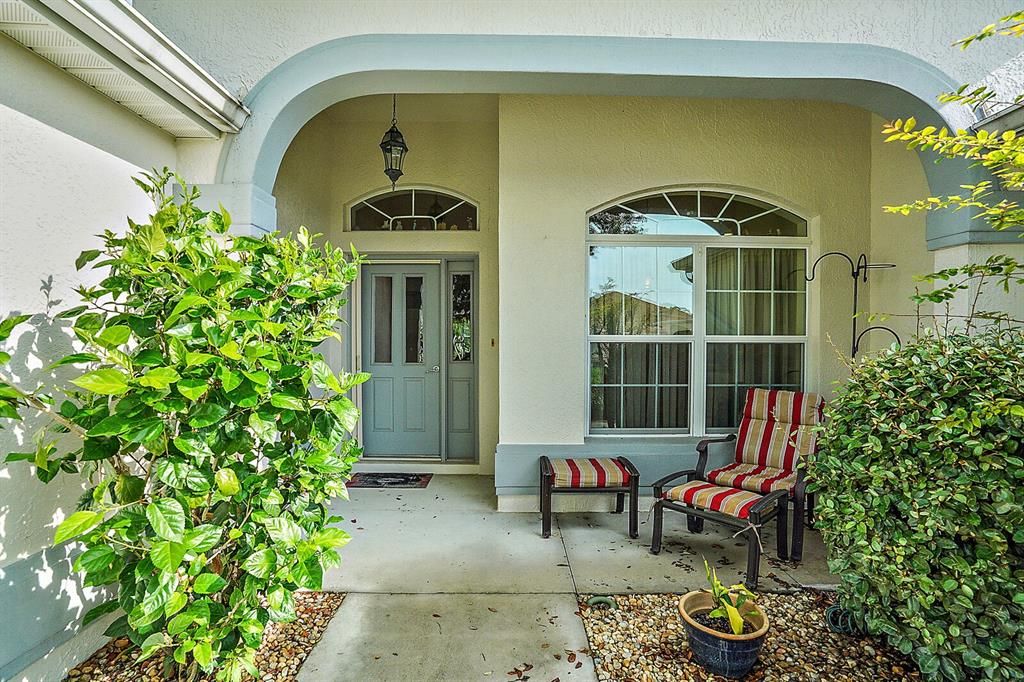 Covered front entrance with elegant leaded glass door