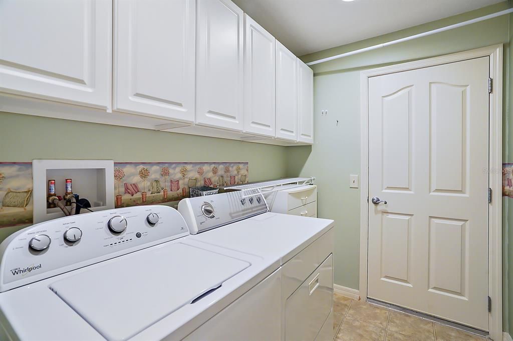 Inside laundry room with extra cabinets