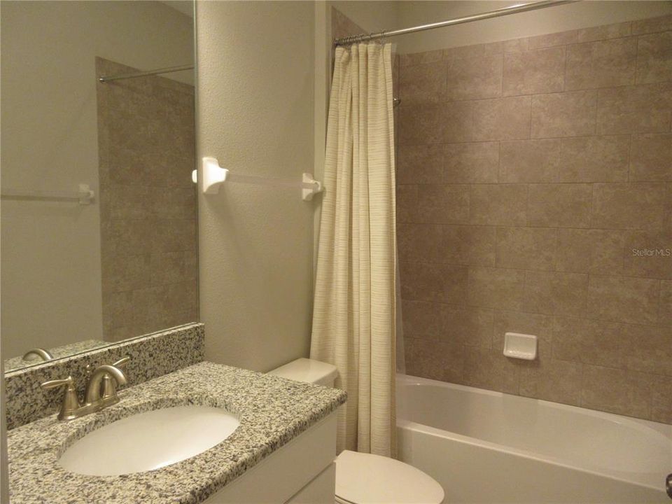 Bathroom 2 is located between Bedrooms 2 & 3; granite counter with undermount sink
