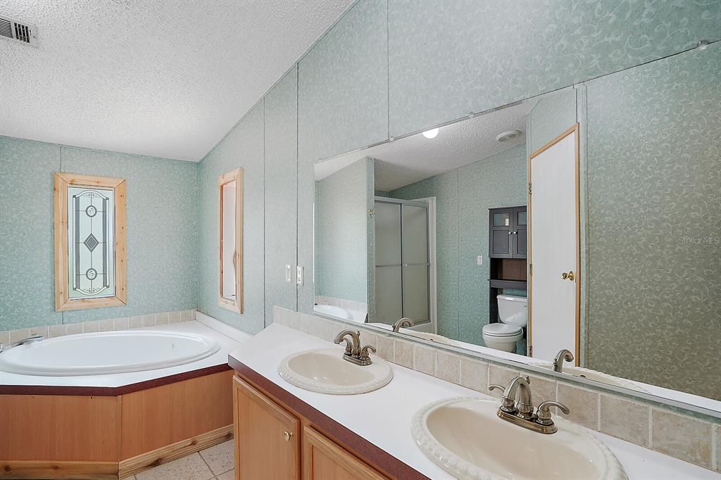 Tile flooring in the owner's bathroom, 2 sinks and generous vanity ~