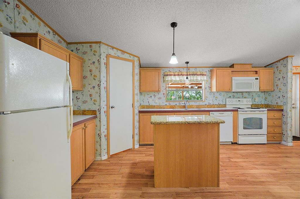Spacious kitchen with a granite top island ~