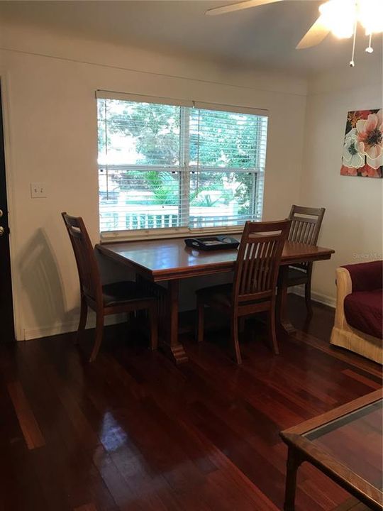 Dining room area with large window looking over front yard with large oaks.