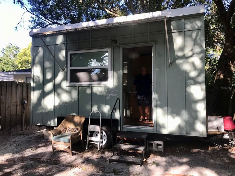 Tiny house 96 sq ft. Queen drop down bed, a/c unit, table and chairs, kitchen unit with refrig/freezer combo, & bath room.  Water avail but not sewer.
