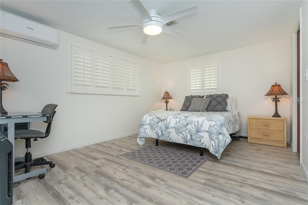 Master suite with walk-in closet, plantation shutters and beautiful vinyl plank flooring
