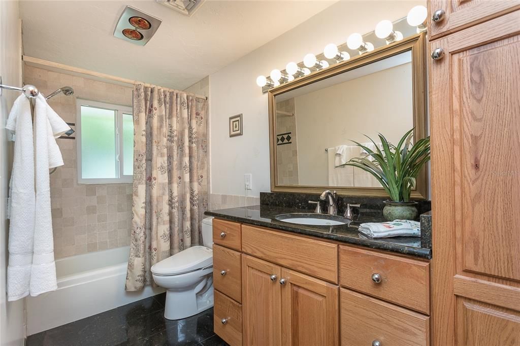 Bathroom 2 with granite countertops and floors