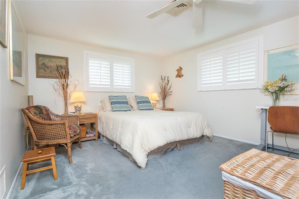 Bedroom 2 with plantation shutters is light and bright