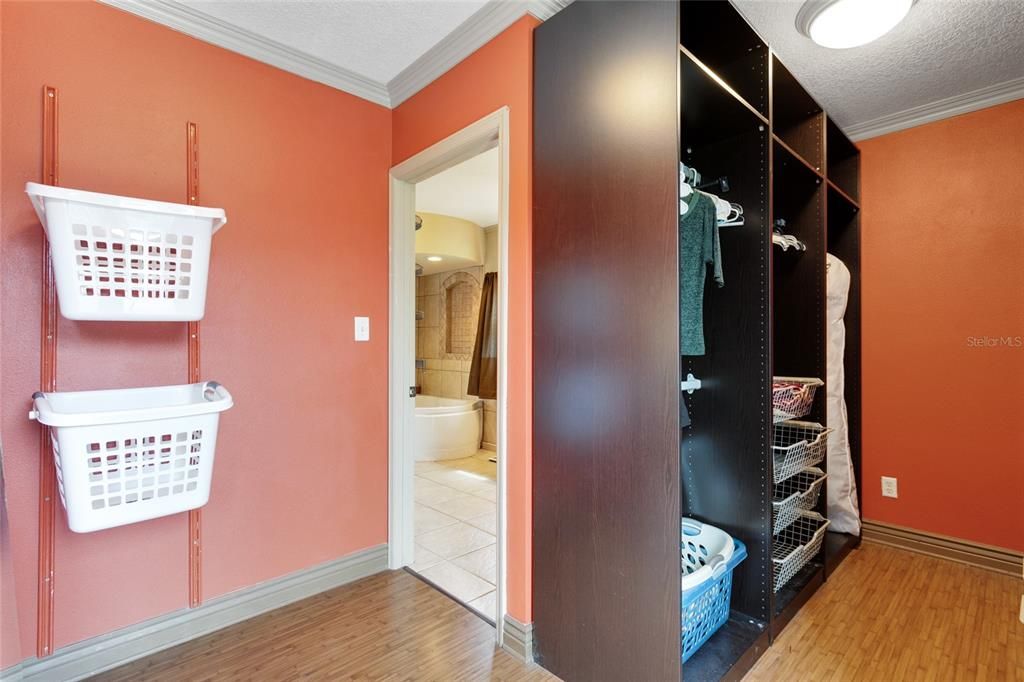 A walk-in closet provides you with plenty of space to organize your wardrobe.