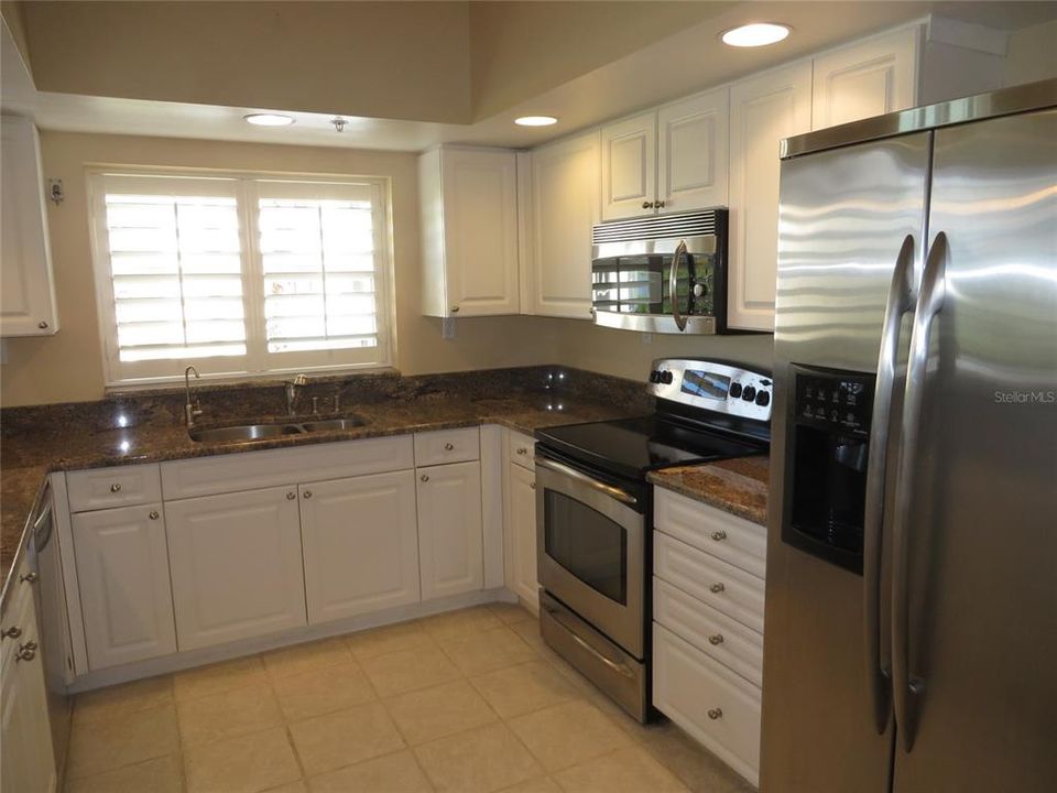 Kitchen features granite counter tops and stainless steel appliances.