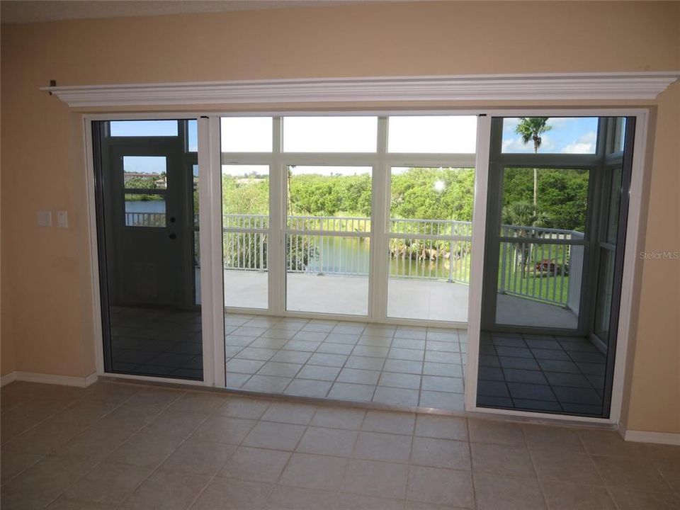 This condo features a glass-enclosed lanai along with an outside deck.