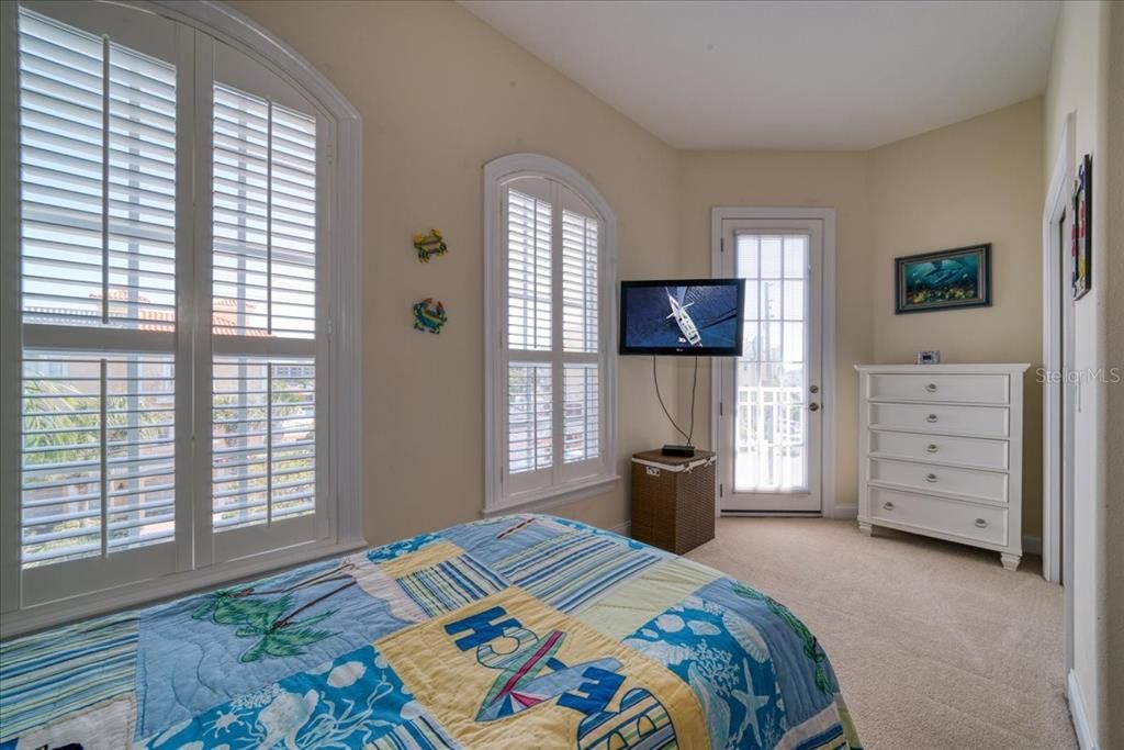 Beautiful plantation shutters add warmth and character to the room along with it's private balcony!
