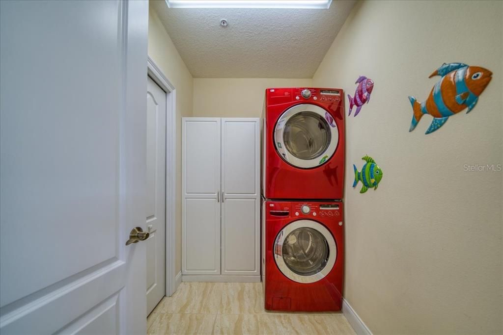 Spacious laundry room with newer full size washer and dryer.