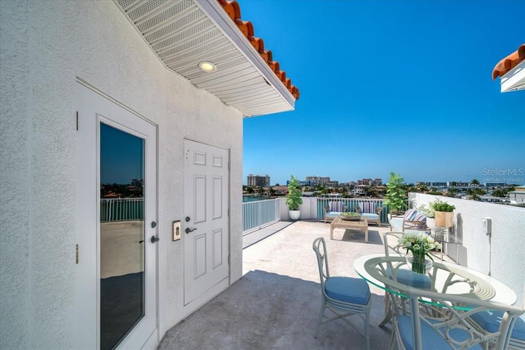 Doorway and elevator door on your expansive roof top terrace which has great views of the Intercoastal, partial gulf views and spectacular sunsets. This picture has been virtually staged.