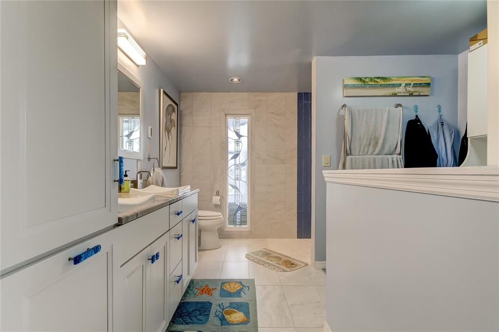 Master Bathroom with dual sinks & walk in closet area.