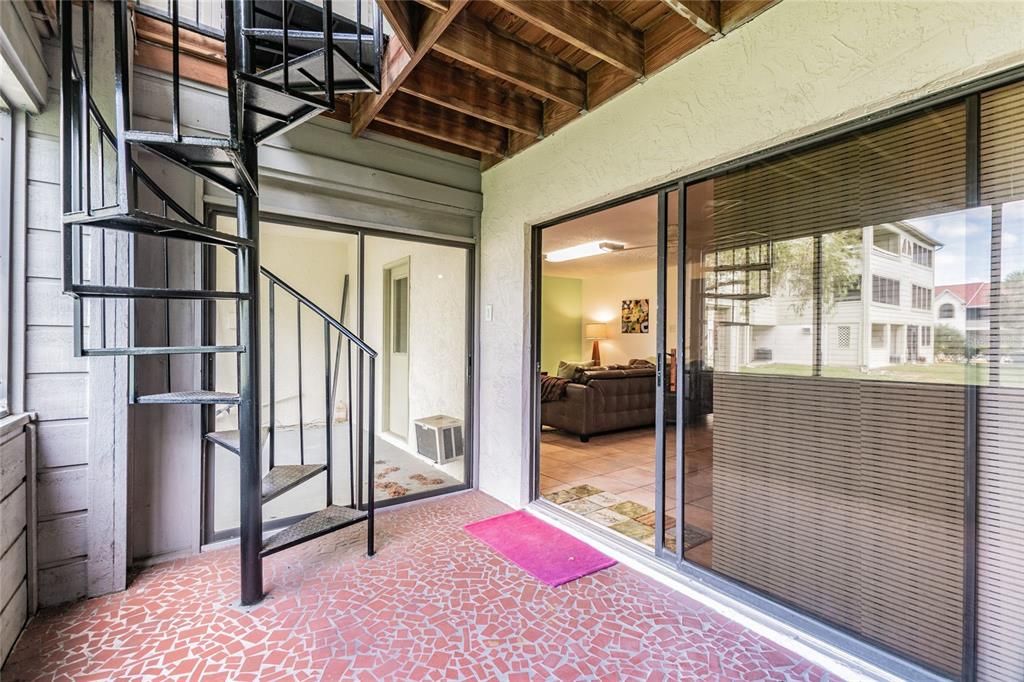 Spiraling down to another large screened-in porch off the bonus room. It doubles your outdoor living space. You can either chill or grill since there is also a large cement pad outside for your grill and more patio furniture.
