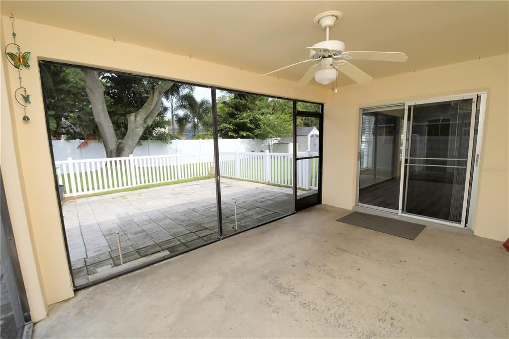 Back yard screened porch with fan and access to family room and Bedroom 2!