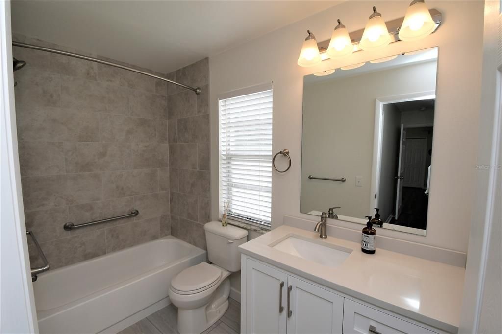 Durable vinyl plank flooring in both bathrooms makes clean up a breeze!