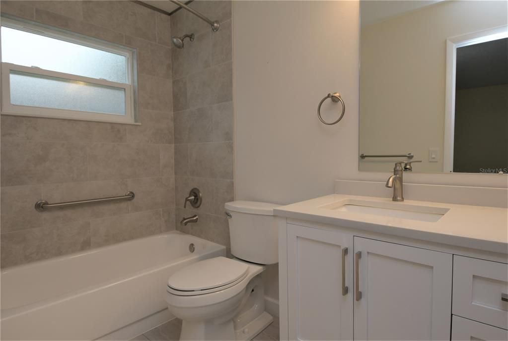 Newly remodeled master bath with solid surface counter, ceramic tile and new window!